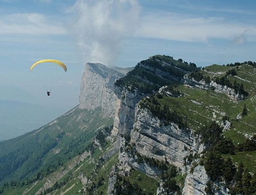 Parapente amarelo voando sobre a Coupe Icare na França